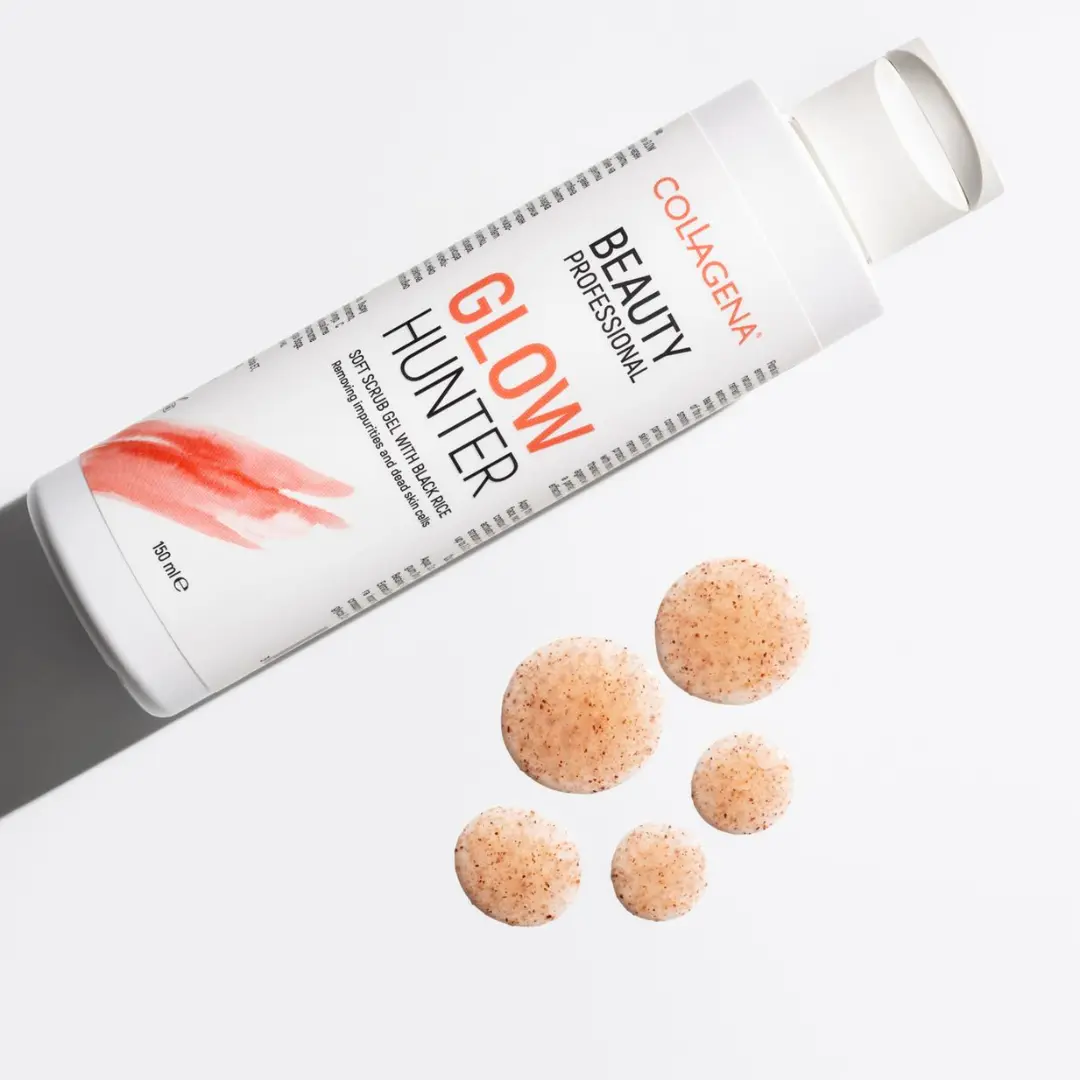 Glow Hunter Facial Exfoliant from the Beauty Professional line, lying beside four exfoliating beads