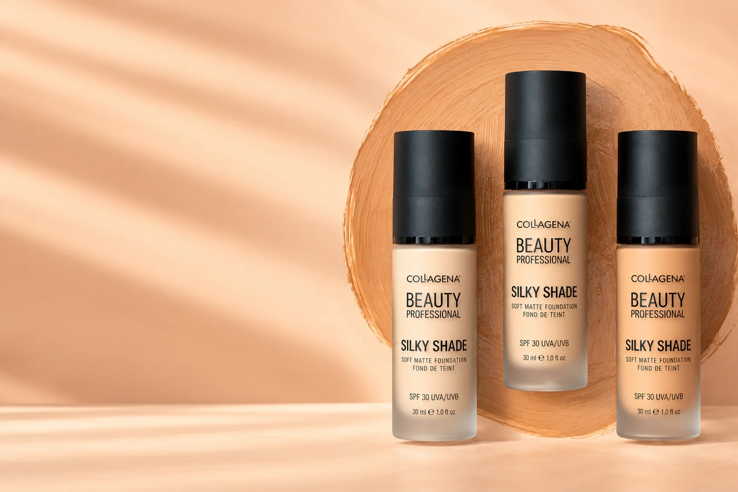 Три фон дьо тена Collagena Beauty Professional Silky Shade Soft Matte SPF 30 вдясно, върху петно фон дьо тен, на прасковен фон със светли ивици